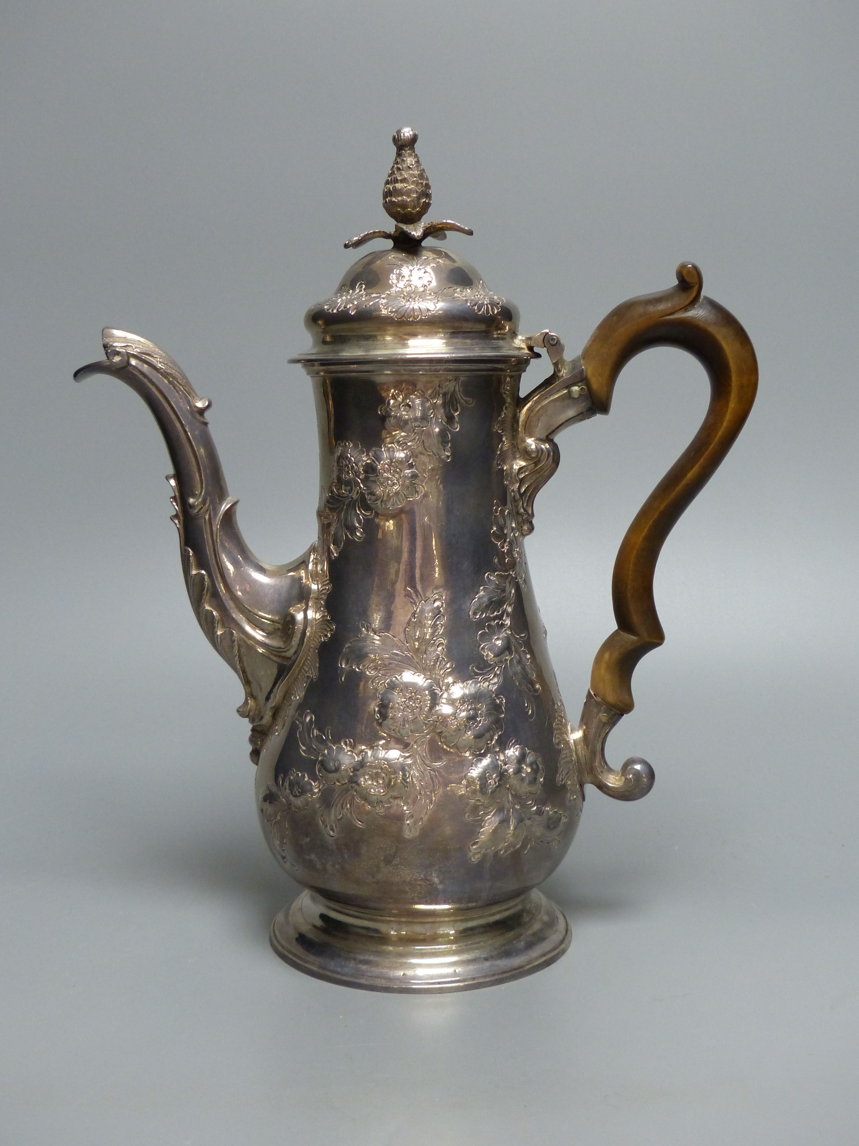 An early George III silver coffee pot, with later embossed decoration, maker ?D over WI,